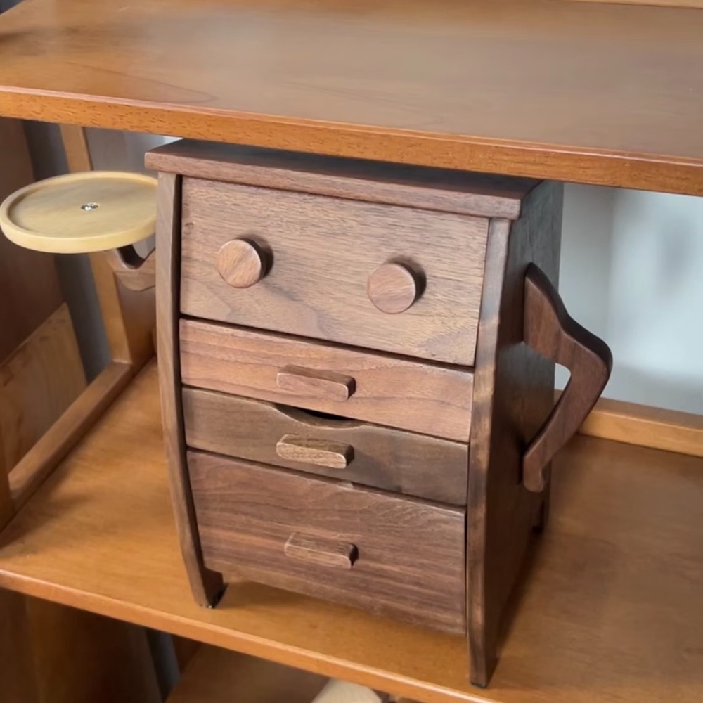 Decorative wooden cabinet with a side arm. It’s made of American walnut wood.